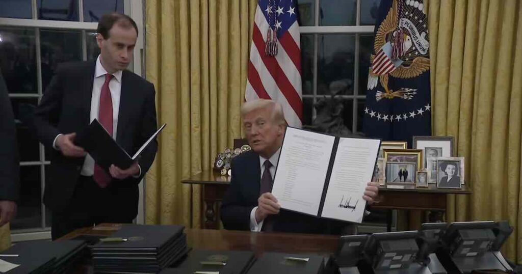 President Donald Trump signs executive orders in the White House, January 2025.